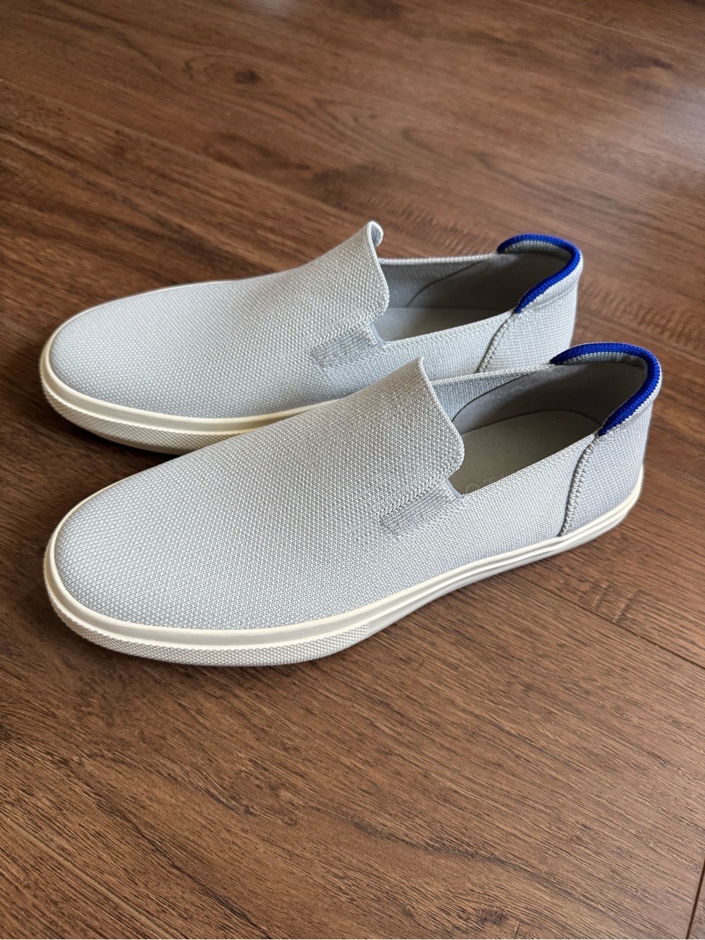 Rothy’s Slip-On Canvas Sneakers in Light Gray with Blue Heel Trim